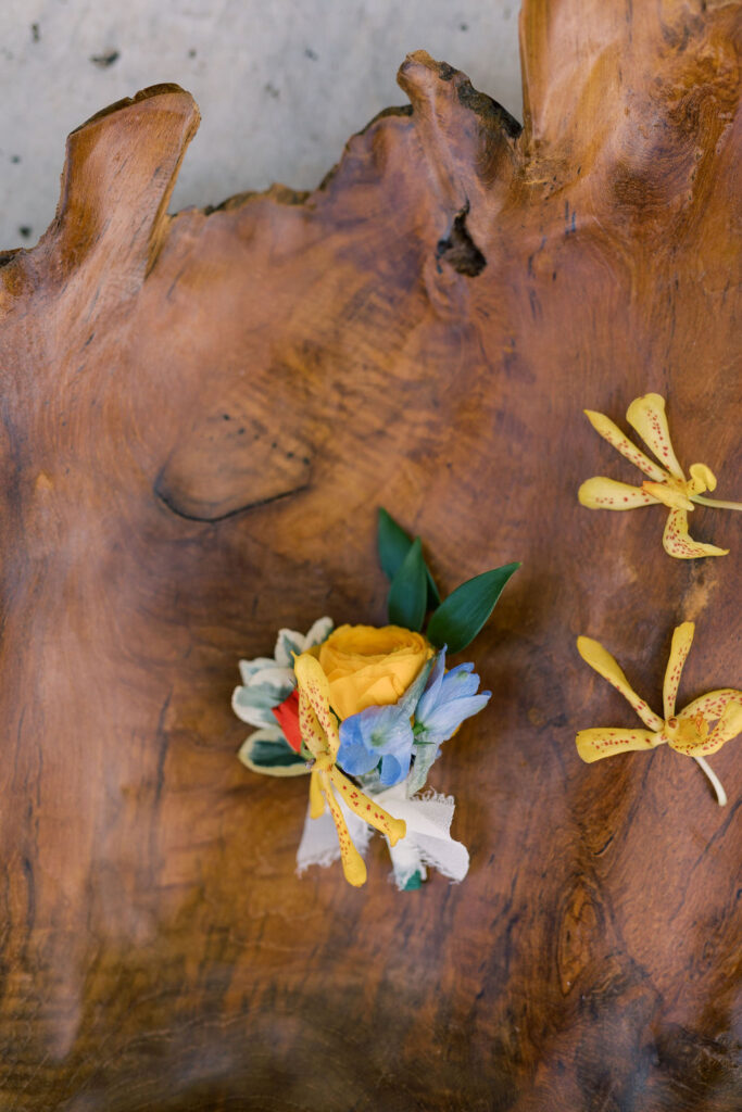 Close-up of a stylish boutonniere featuring vibrant flowers, designed by Kendra’s Events.