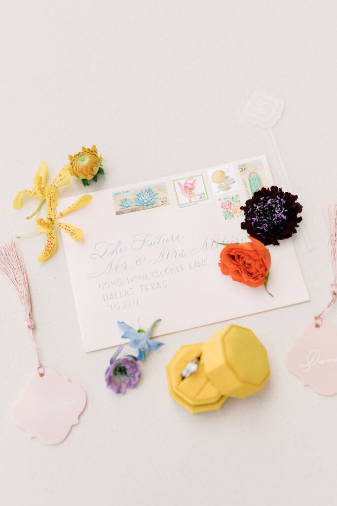 Elegant wedding invitation adorned with vibrant floral accents, designed by Kendra’s Events.