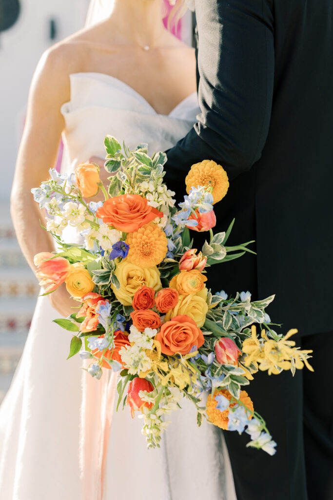 Colorful garden-style bridal bouquet with vibrant flowers, perfect for a joyful wedding celebration.